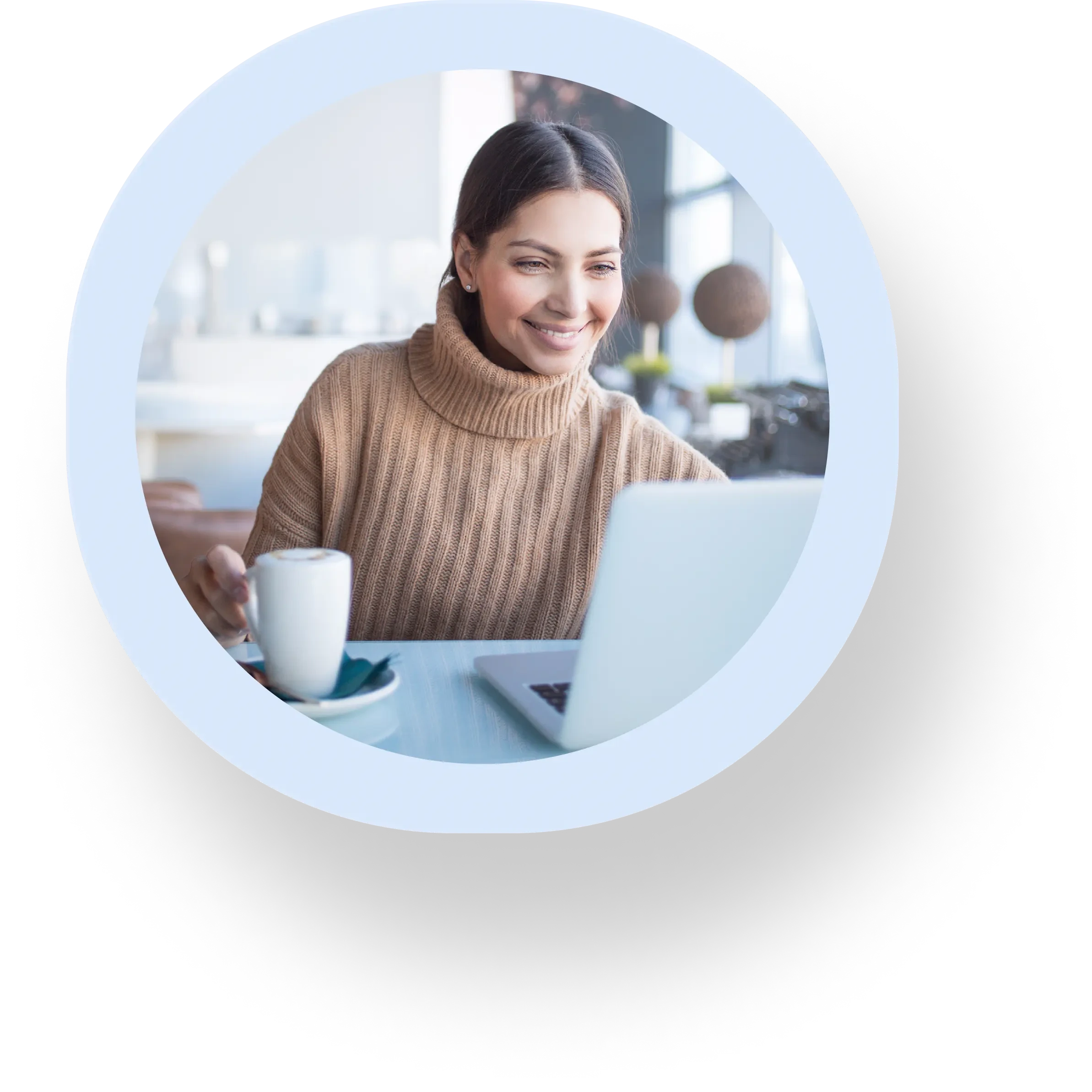 women is smiling and looking at laptop